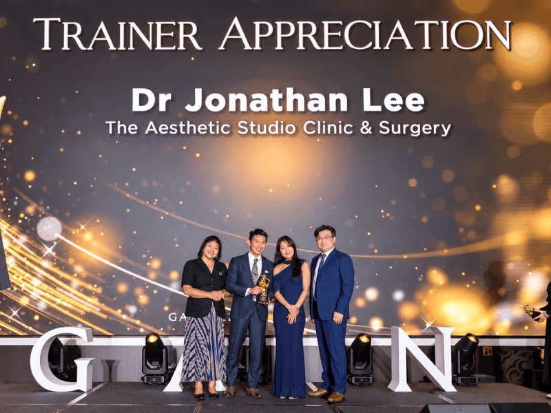 Dr. Jonathan Lee with his professional awards in aesthetic medicine