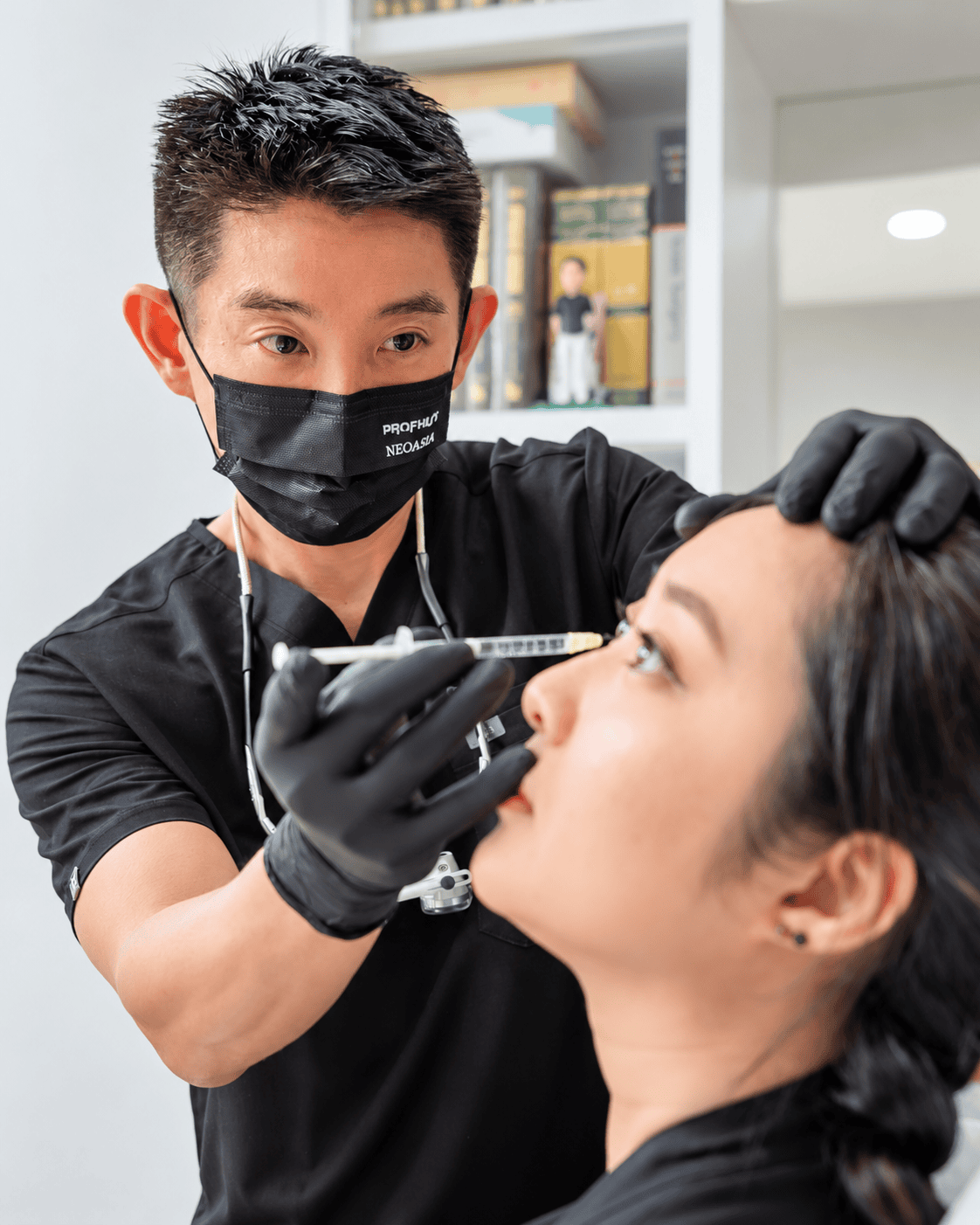 Dr. Jonathan Lee performing an aesthetic treatment at The Aesthetic Studio Clinic