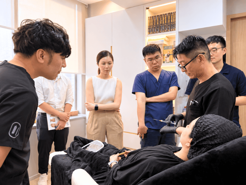 r. Jonathan Lee teaching facial anatomy to doctors at a training workshop